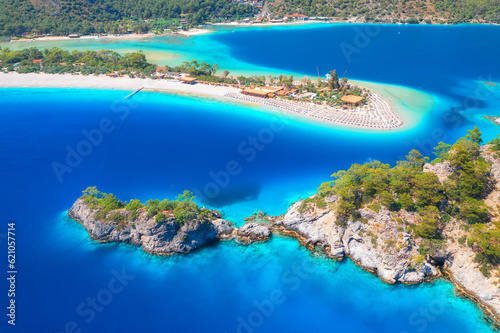 Fototapeta Naklejka Na Ścianę i Meble -  Aerial view of sea bay, rock, sandy beach, trees, mountain at sunny day in summer. Blue lagoon in Oludeniz, Turkey. Tropical landscape with island, white sandy bank, blue water. Top view. Nature