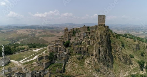 Aerial drone view in Craco, Italy. Small town built on a clay hill. Ghost town causes landslides and earthquake. An isolated ghost town set famous for horror films and dramatic sceneries.