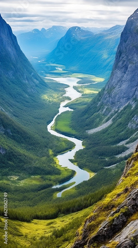 beautiful landscape mountain range with a river and a cloudy sky