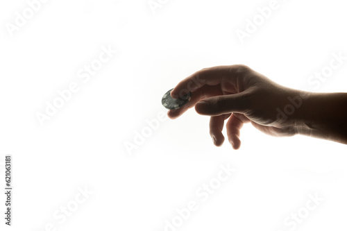 A man's hand holds poker chips on a white background. Chip for gambling in a casino in a man's hand.