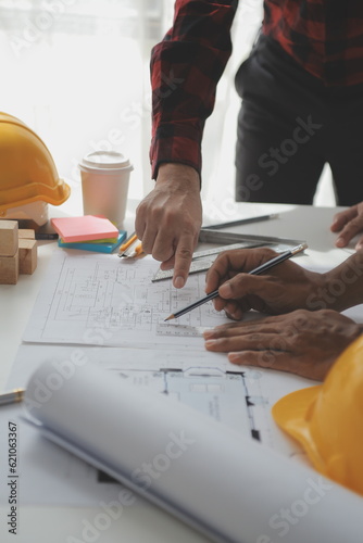 Construction and structure concept of Engineer or architect meeting for project working with partner and engineering tools on model building and blueprint in working site, contract for both companies. photo