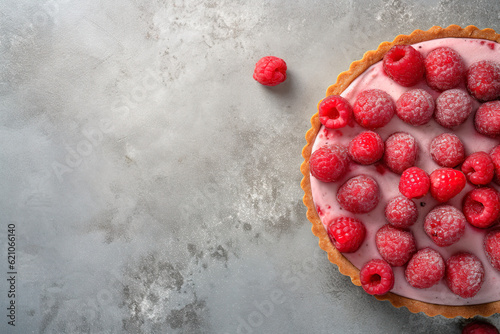 A close - up shot of Raspberry Rosewater Tart, light gray textured plaster background, top view.