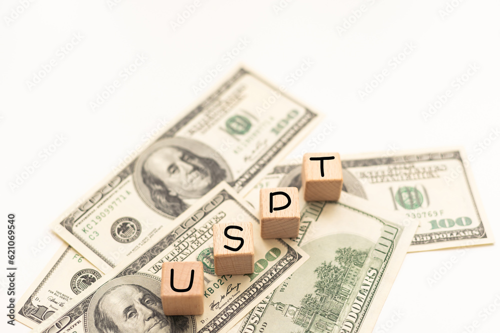 Money, US Dollar. Alphabet in wooden cubes forming the acronym USD over many US dollar banknotes. Concept for American economy, international business, foreign exchange market and investments. Money, US Dollar. Alphabet in wooden cubes forming the acronym USD over many US dollar banknotes. Concept for American economy, international business, foreign exchange market and investments.