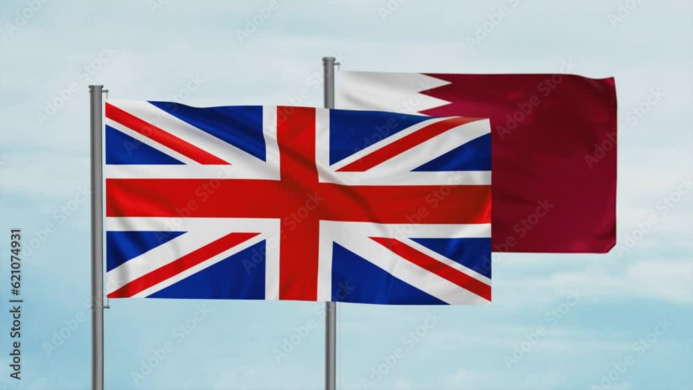 Qatar and United Kingdom, UK flag waving together in the wind on blue sky, cycle looped video, two country cooperation concept Qatar and United Kingdom, UK flag waving together in the wind on blue sky, cycle looped video, two country cooperation concept