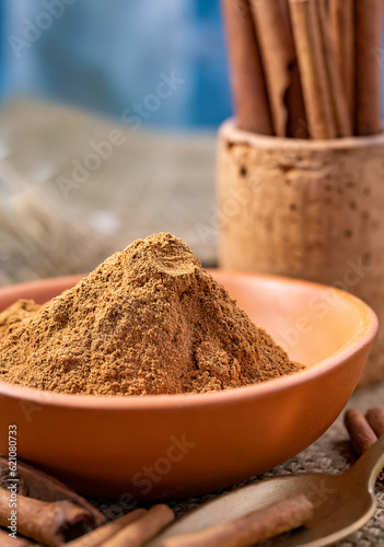 Cinnamon powder placed in ceramic bowl viewed from above