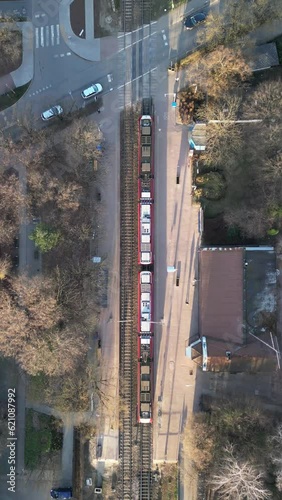 Aerial Horizontal View of WKD Railway and Following a Train in Podkowa Lesna, Warsaw, Poland (ID: 621087992)