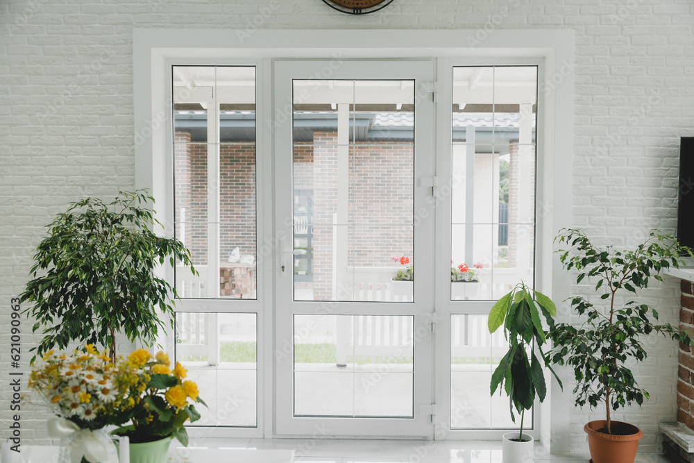a white hotel with a large glass door to the garden. a white hotel with a large glass door to the garden.
