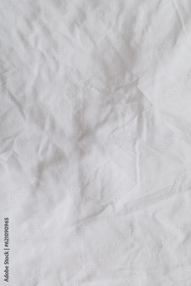 Closeup of a messy bedding sheet. Crumpled bedding sheet for background and decoration. Minimal background and texture concept. Flat lay, top of view. Copy space for text. Closeup of a messy bedding sheet. Crumpled bedding sheet for background and decoration. Minimal background and texture concept. Flat lay, top of view. Copy space for text.