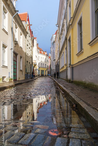 Wet cobblestones after rain on a narrow street in the old town of Tallinn, Estonia. Cozy street in Tallinn