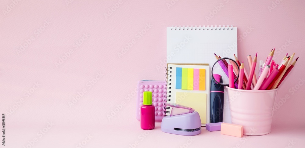 On a pink background, school supplies for drawing and learning. Notebooks, notebooks, pencils and markers. Copy space for text, front view, background. Concept back to school. On a pink background, school supplies for drawing and learning. Notebooks, notebooks, pencils and markers. Copy space for text, front view, background. Concept back to school.