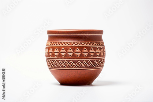 Hyper - realistic photo of a beautiful handmade terracotta pot, intricate geometric patterns, warm earthy tones, set against a minimalist white backdrop