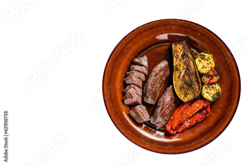 Grilled mutton tenderloin Fillet Meat, lamb sirloin on rustic plate with vegetables. High quality Isolate, transparent background