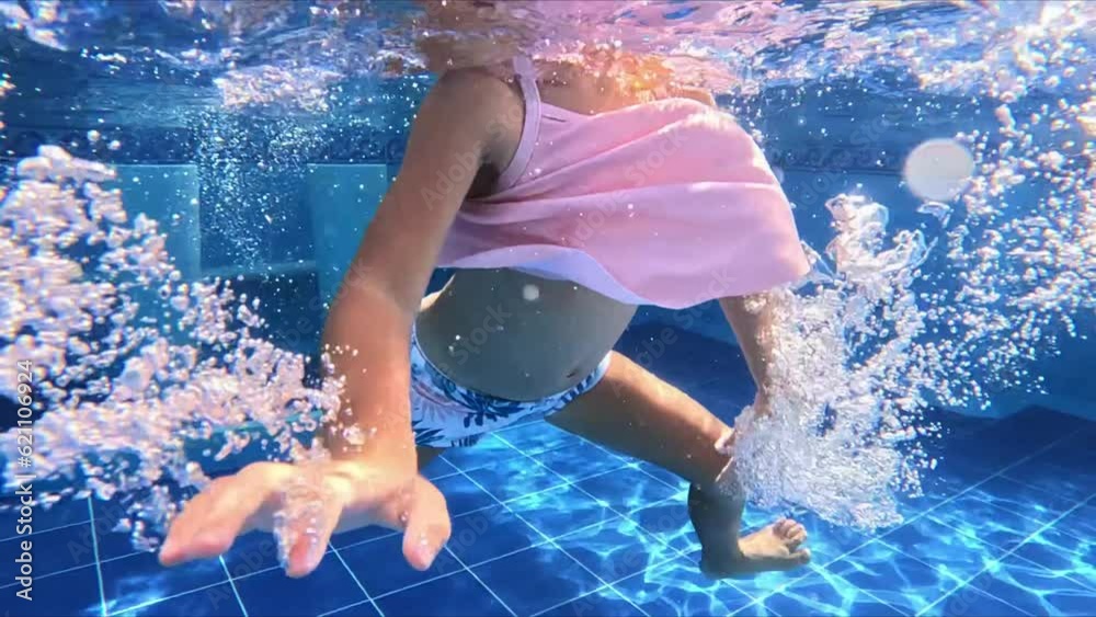 little girl swims with glasses in the pool