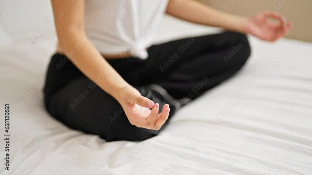 Young beautiful hispanic woman doing yoga exercise sitting on bed at bedroom Young beautiful hispanic woman doing yoga exercise sitting on bed at bedroom