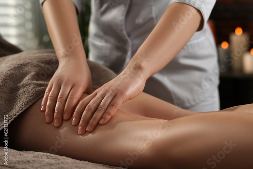 Woman receiving leg massage in spa salon  closeup