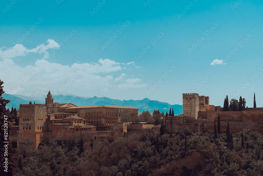 Granada,Spain. April 14, 2022: Alhambra castle panoramic landscape with blue sky. Granada,Spain. April 14, 2022: Alhambra castle panoramic landscape with blue sky.