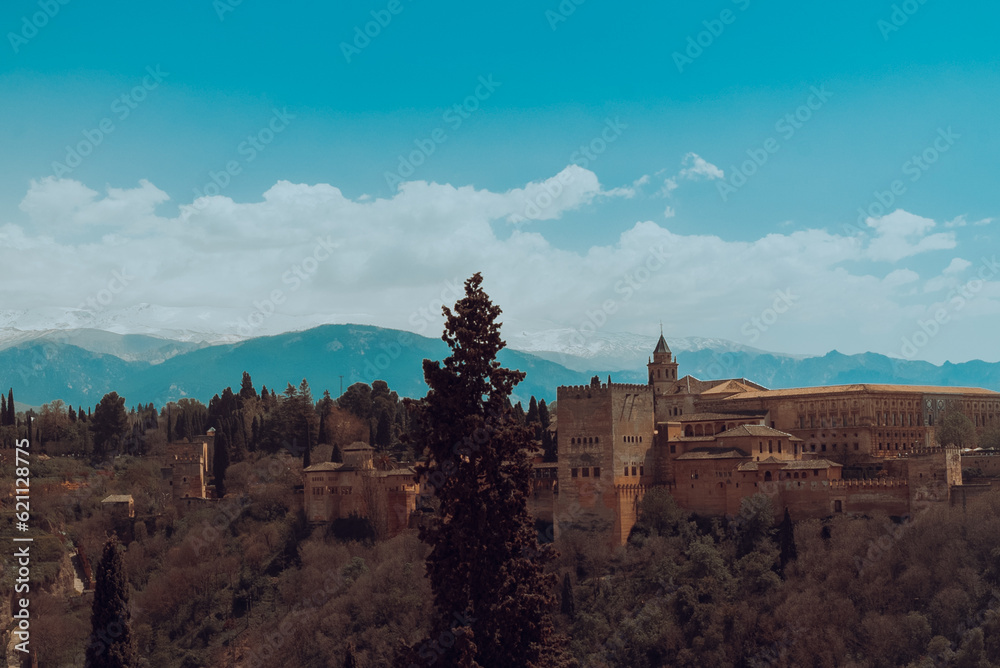 Granada,Spain. April 14, 2022: Alhambra castle panoramic landscape with blue sky. Granada,Spain. April 14, 2022: Alhambra castle panoramic landscape with blue sky.