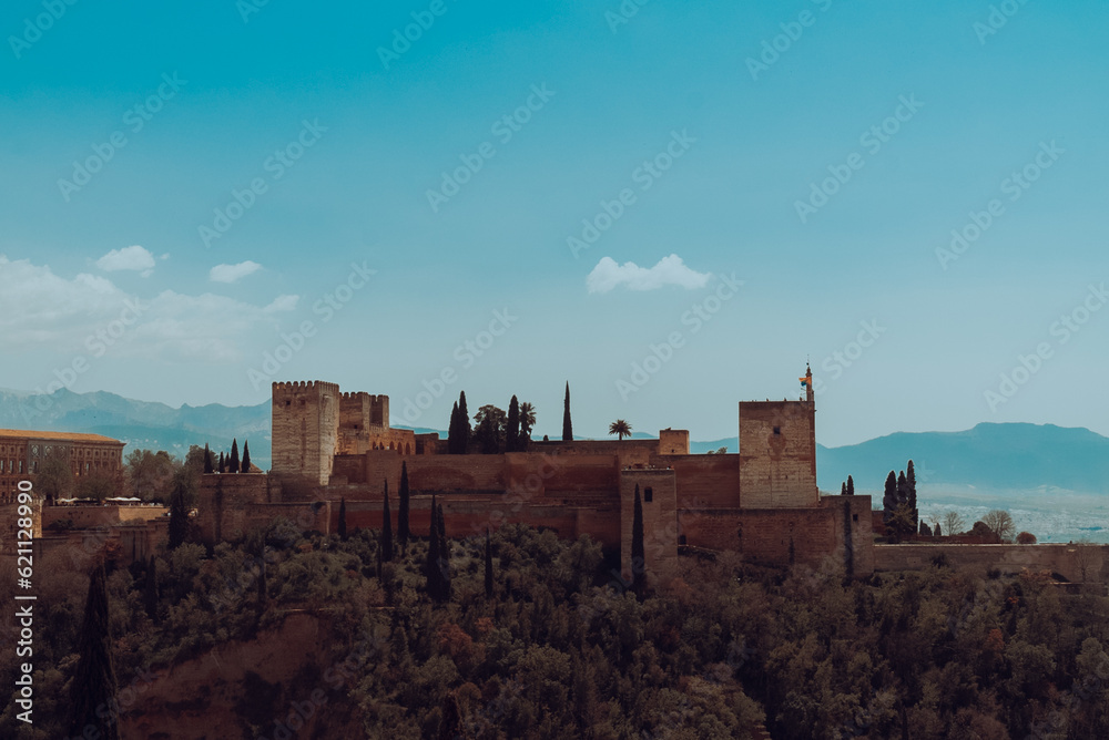 Granada,Spain. April 14, 2022: Alhambra castle panoramic landscape with blue sky. Granada,Spain. April 14, 2022: Alhambra castle panoramic landscape with blue sky.