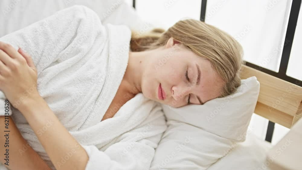 Young blonde woman lying on bed sleeping at bedroom Young blonde woman lying on bed sleeping at bedroom