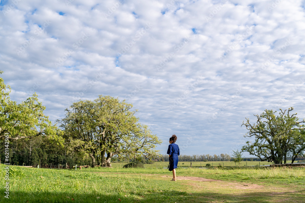 Woman walking outdoors in the field. Woman walking outdoors in the field.