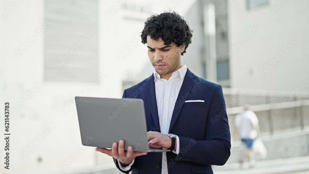 Young latin man business worker using laptop at street Young latin man business worker using laptop at street