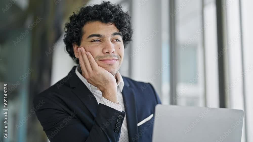 Young latin man business worker using laptop thinking at office Young latin man business worker using laptop thinking at office