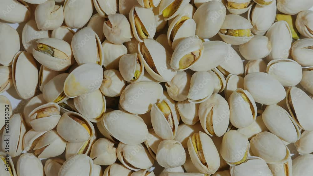 Fresh and organic pistachios in a heap, natural texture and yellow color. Perfect for a nutritious and delicious treat. Fresh and organic pistachios in a heap, natural texture and yellow color. Perfect for a nutritious and delicious treat.