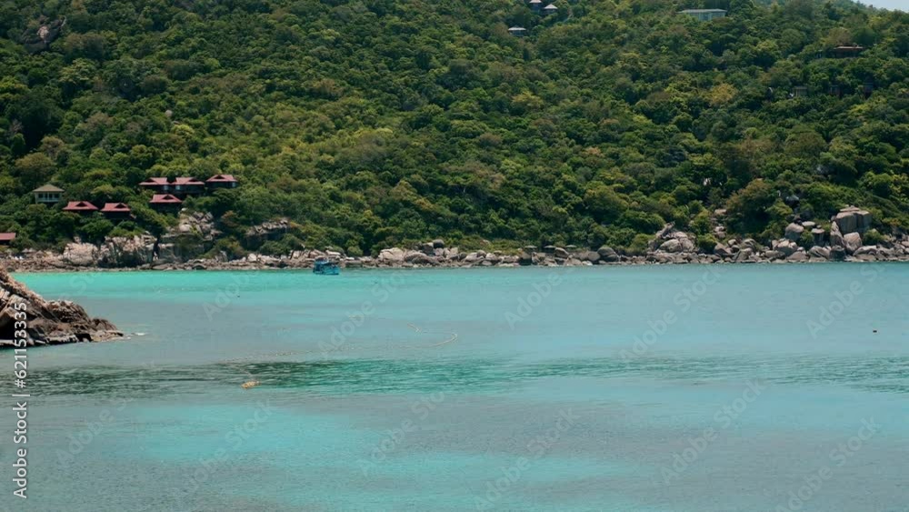 Turquoise sea meets lush green tropical forest in a stunning landscape. Nature's beauty on display in this idyllic island paradise. Concept of natural beauty and vacation. Turquoise sea meets lush green tropical forest in a stunning landscape. Nature's beauty on display in this idyllic island paradise. Concept of natural beauty and vacation.