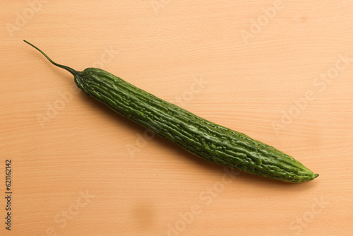 Momordica charantia or Bitter Gourd, in Indonesia called pare on wooden background