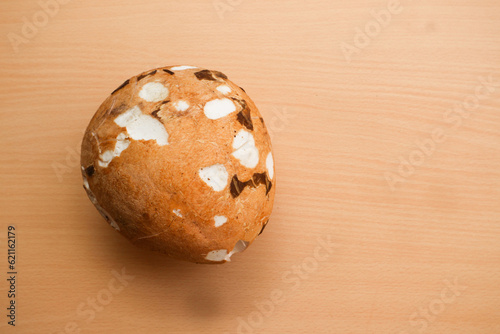 Peeled coconut on the wooden background