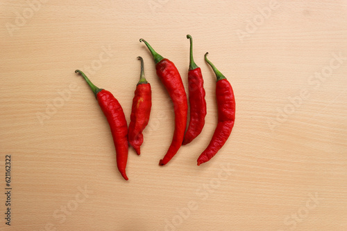 Old red chili pepper on wooden background