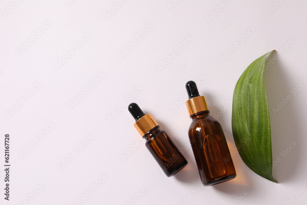 Essential oil bottles on wooden background