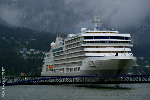 Luxury Silver cruiseship cruise ship liner Muse arrival into port of Juneau, Alaska during nature adventure Last Frontier cruising with dramatic panoramic landscape vacation © Tamme