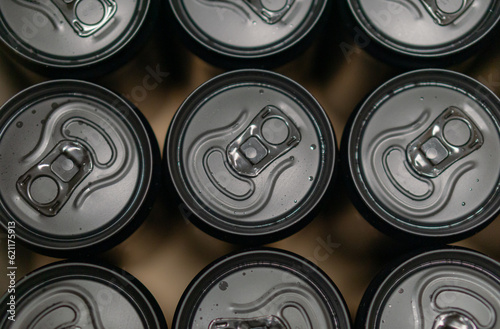 Background of black slim aluminium drink cans from top