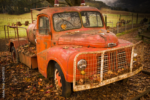 Old vintage Red Fire engine lying to rest in autumn leaves