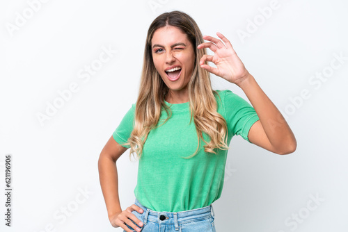 Young Uruguayan woman isolated on white background showing ok sign with fingers