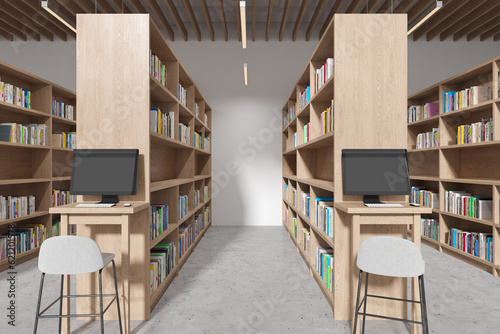 Minimalist library interior with bookshelves and desk with pc monitor