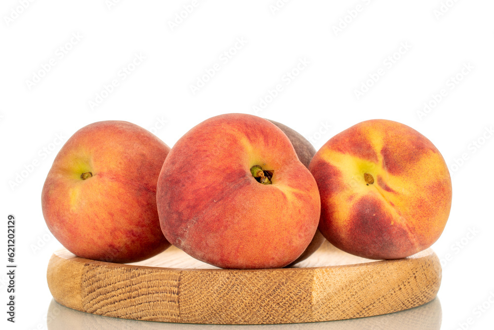Several ripe organic peaches with wooden tray, macro, isolated on white background. Several ripe organic peaches with wooden tray, macro, isolated on white background.