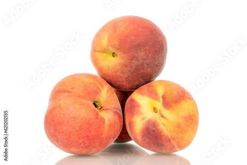 Three ripe organic peaches, macro, isolated on white background.