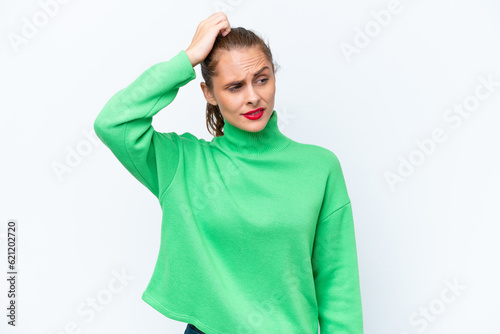 Young caucasian woman isolated on white background having doubts while scratching head © luismolinero