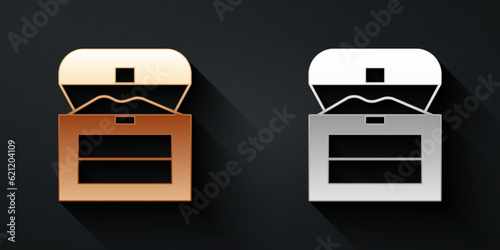 Gold and silver Antique treasure chest icon isolated on black background. Vintage wooden chest with golden coin. Long shadow style. Vector