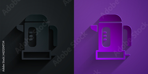 Paper cut Electric kettle icon isolated on black on purple background. Teapot icon. Paper art style. Vector