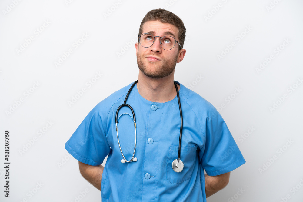 Young surgeon doctor caucasian man isolated on white background and looking up Young surgeon doctor caucasian man isolated on white background and looking up
