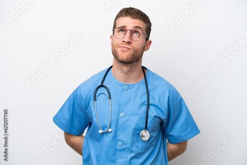 Young surgeon doctor caucasian man isolated on white background and looking up
