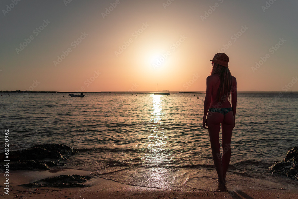 Blonde woman in golden sunset on Mediterranean. Sea Nautical vessel in the sea