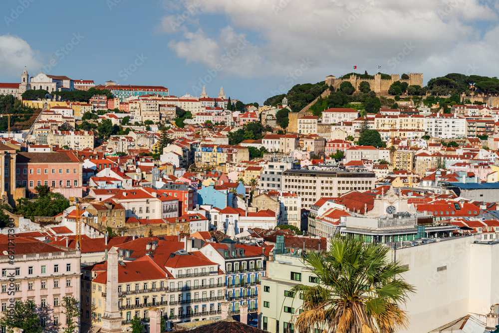 Alfama neighborhood with old buildings in Lisbon with the castle of Saint George on top of the hill,Portugal.