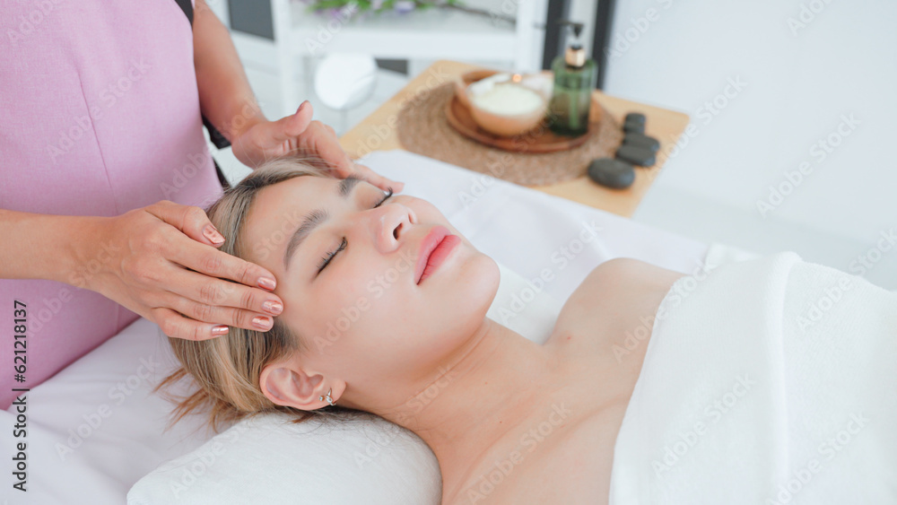 Woman having facial massage by masseuse. Woman having facial massage by masseuse.