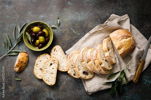 Ciabatta bread sliced on a board, top view