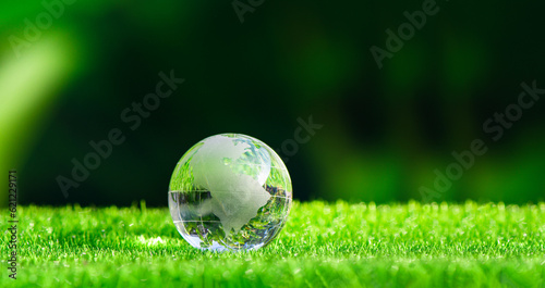 Glass globe in green forest with the icon environment of ESG, co2, circular company, and net zero. Technology Environment, Organization Sustainable development environmental.