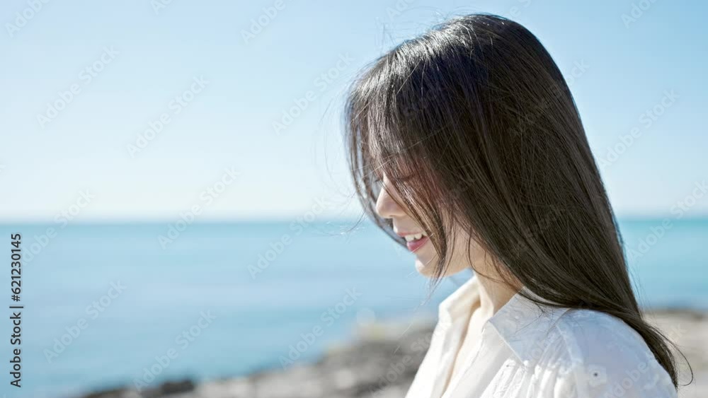 Young chinese woman breathing with closed eyes at seaside Young chinese woman breathing with closed eyes at seaside
